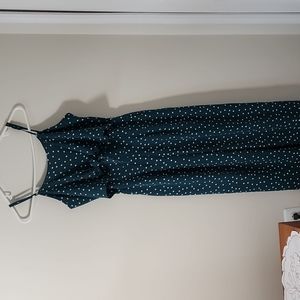 Dark green and white polka dot romper with wide legs.